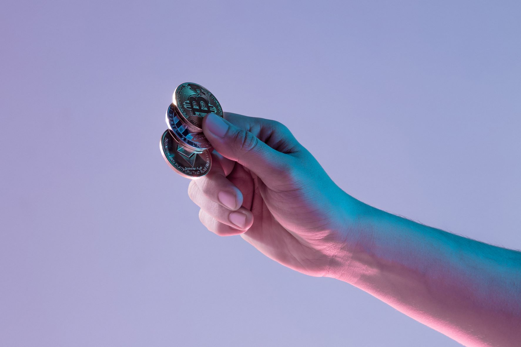 male-hand-with-golden-bitcoin-on-blue-background.jpg